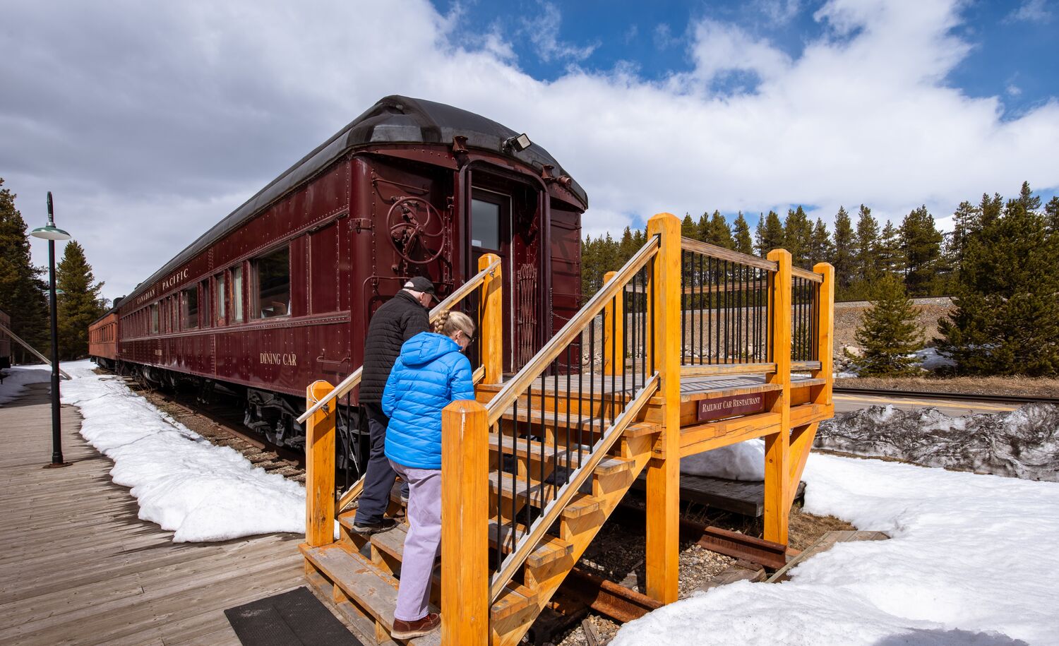 Travelers entering The Station Restaurant in Lake Louise Restored Delamere Dining Car for a private dinner